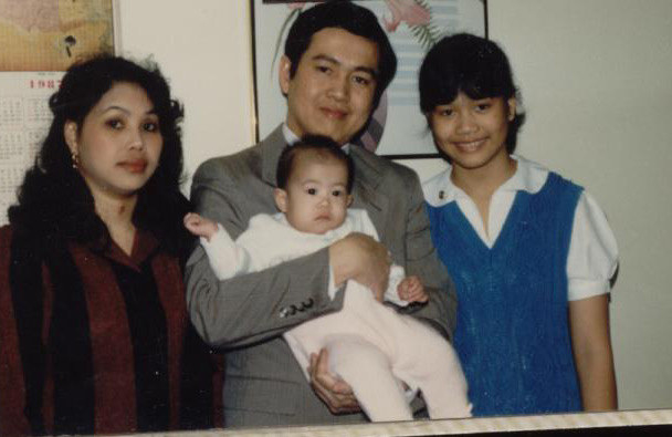 Kim Thai when she was a baby with her parents and sister.