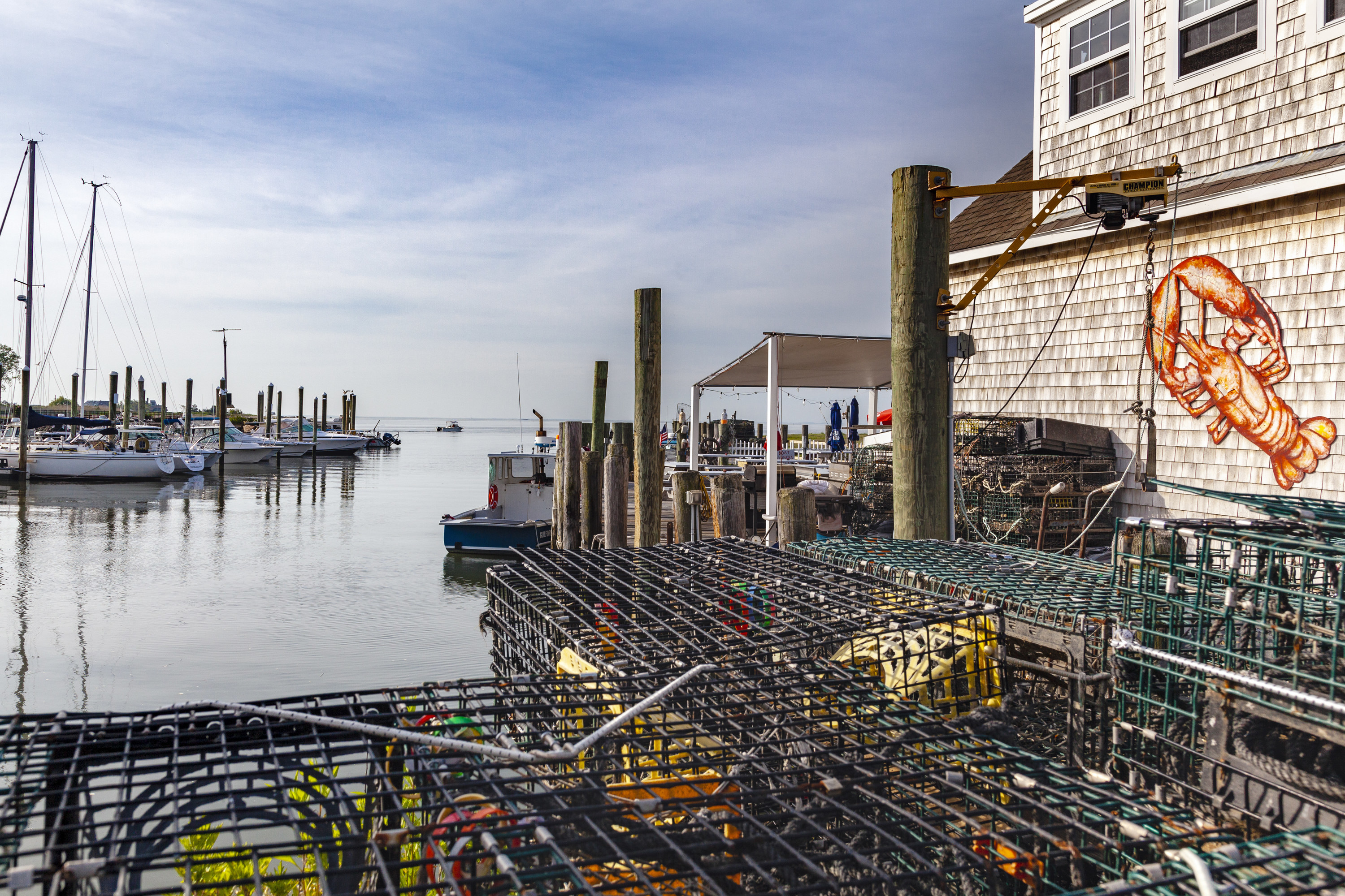 Lobster traps resting on the docks at the Guilford Harbor, in Guilford, CT. The building on the right is a fishing shack, located in Guilford Connecticut, at the Guilford Marina.