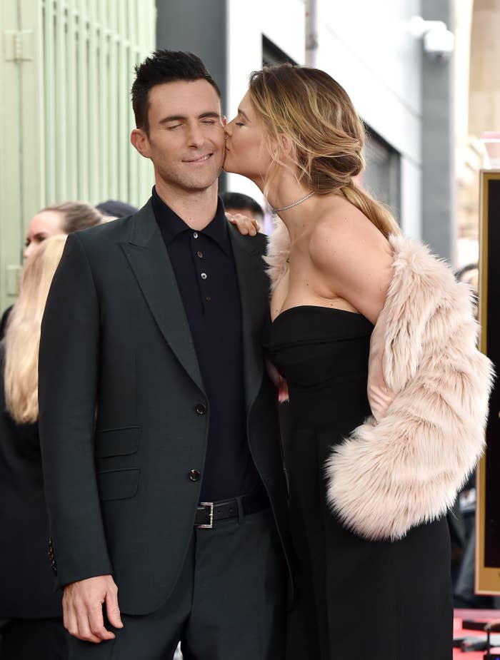 Behati kissing Adam's cheek
