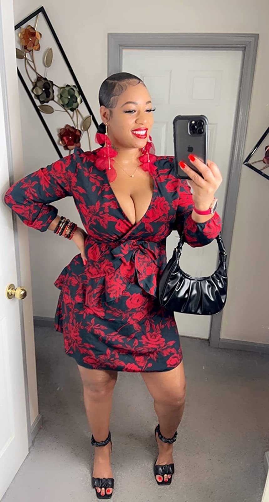 reviewer wearing long sleeve black-and-red floral-print mini dress