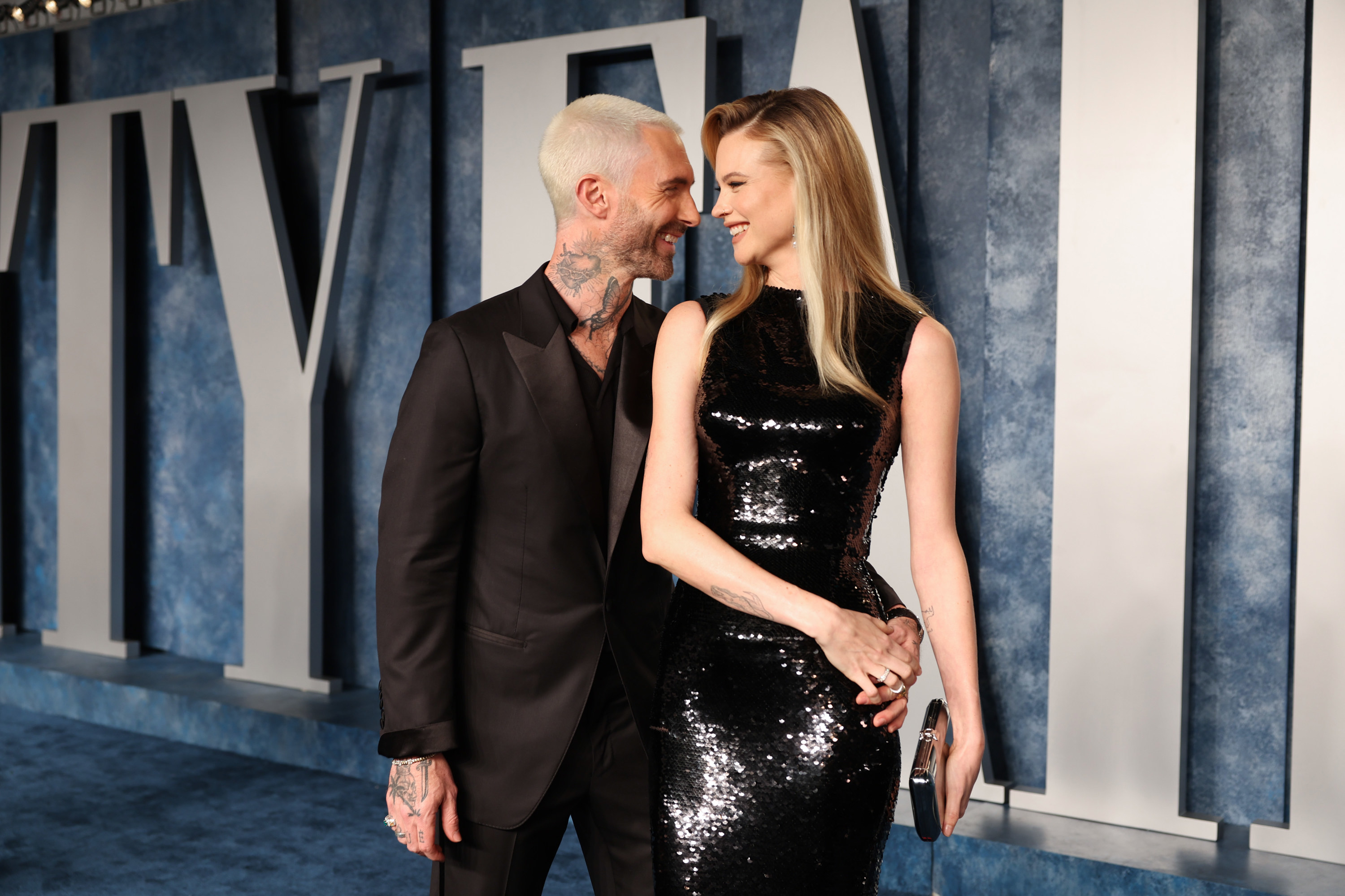 Adam and Behati smiling at each other