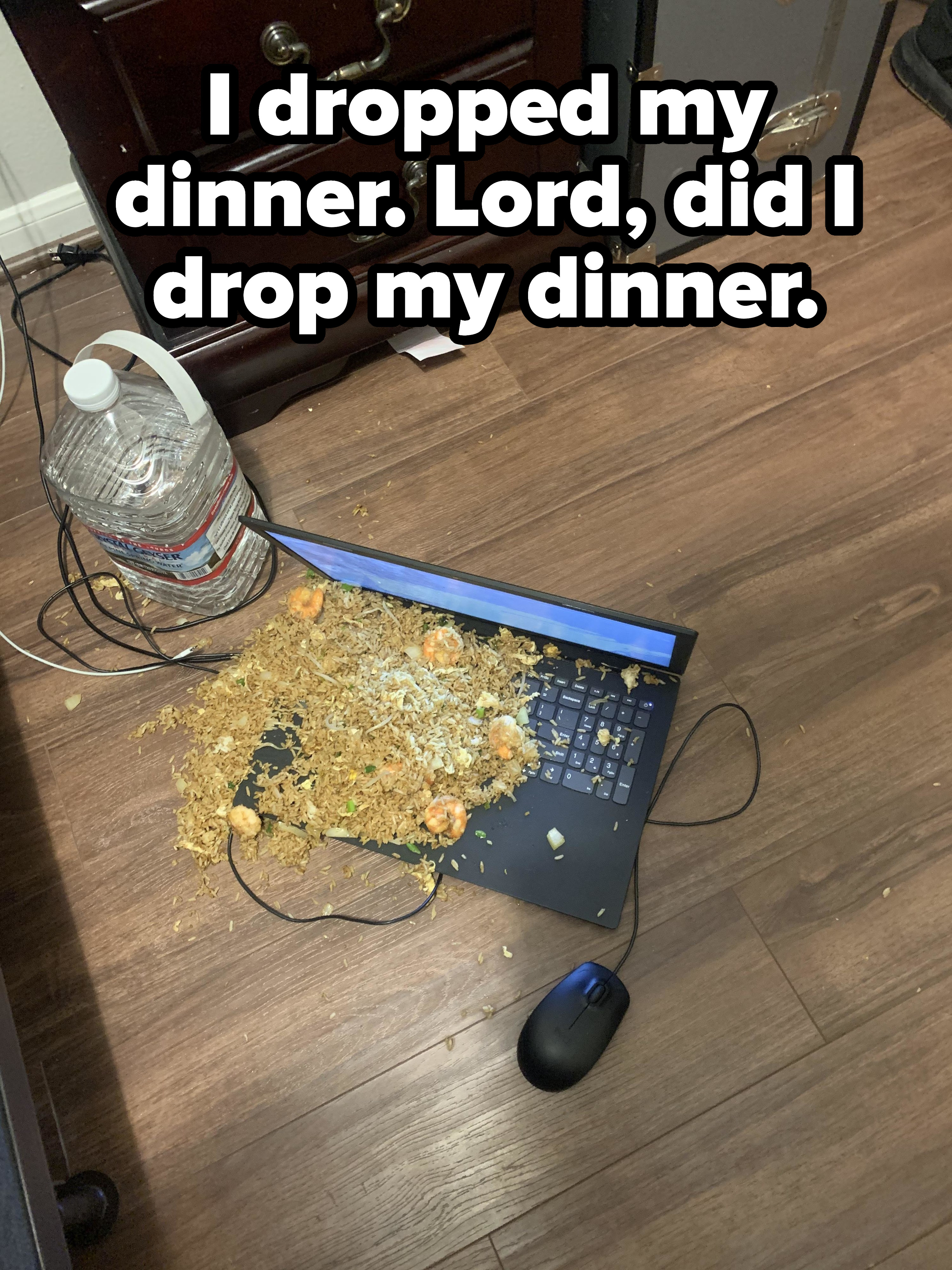 A keyboard on the floor covered in shrimp fried rice