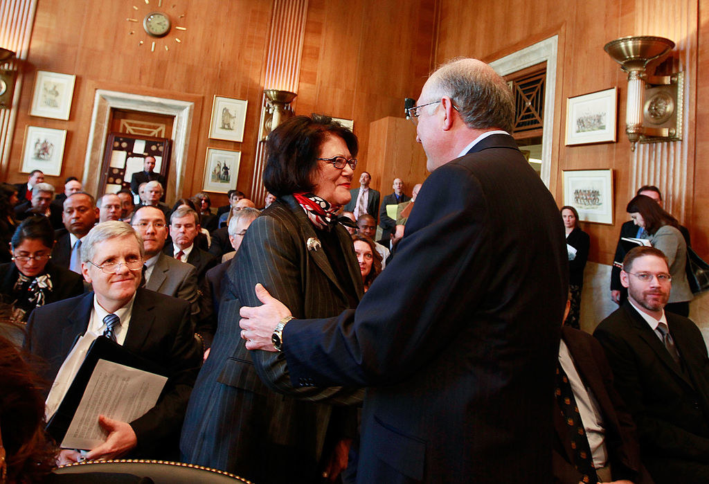Elouise Cobell shakes hands with Secretary of the Interior Ken Salazar in December 2009, during a Senate Indian Affairs Committee hearing on the settlement of the class-action lawsuit Cobell vs Salazar