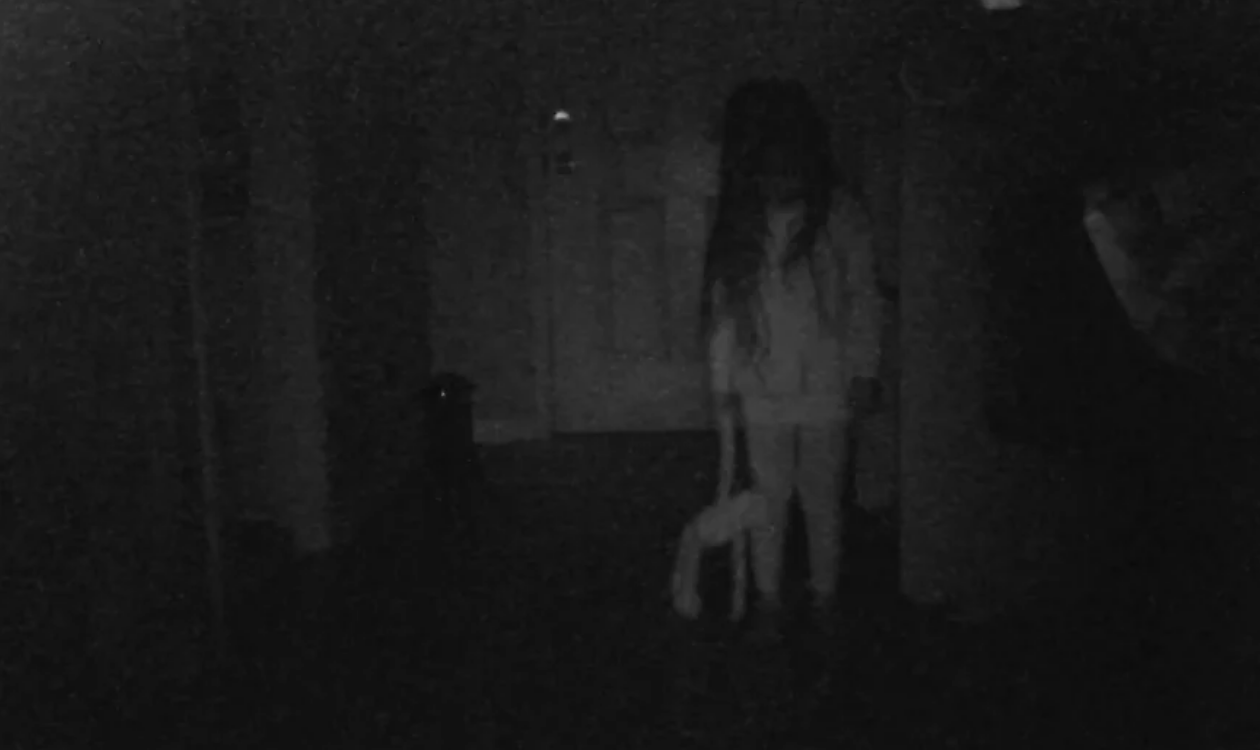 A little girl in a dark room