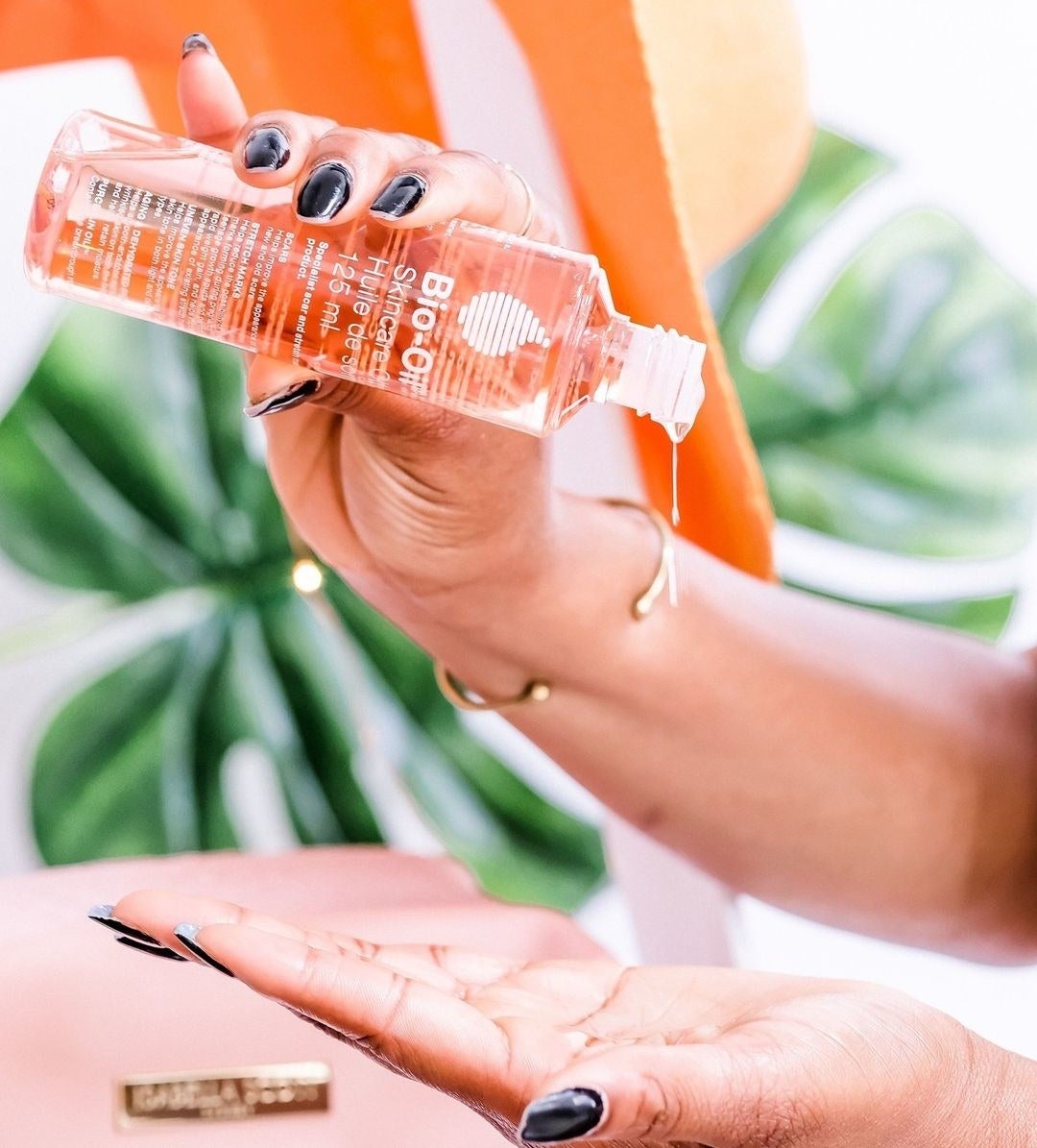 A person pouring Bio-Oil onto their hand