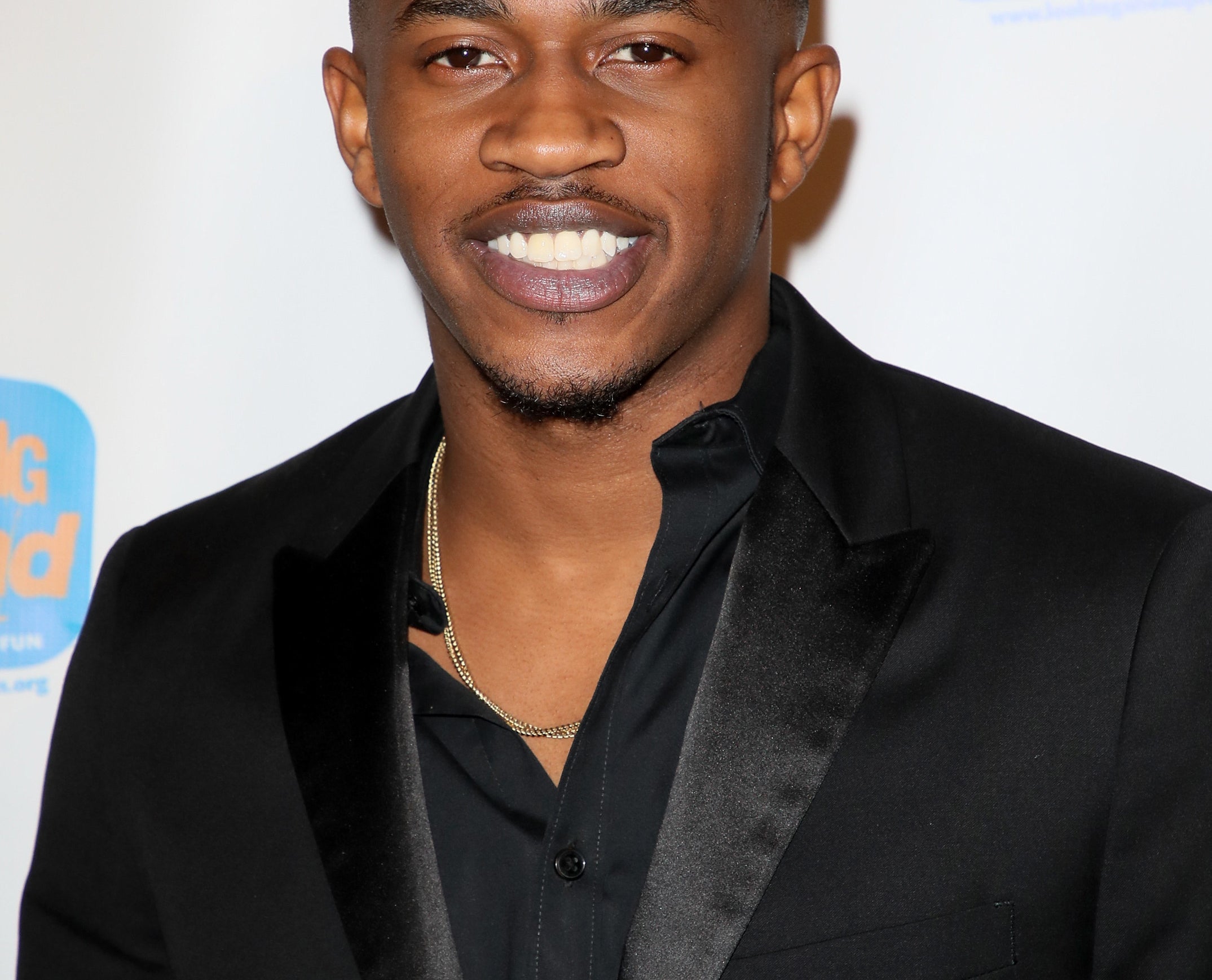 Malcolm David Kelley smiles at red carpet event