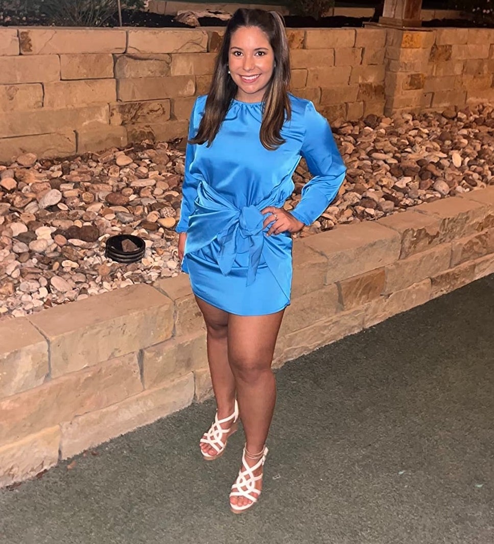 a reviewer wearing the bright blue dress