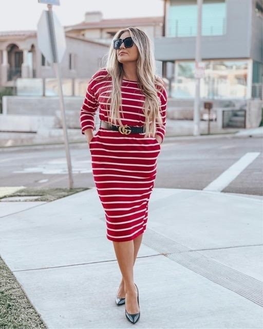 a reviewer wearing the red and white striped dress