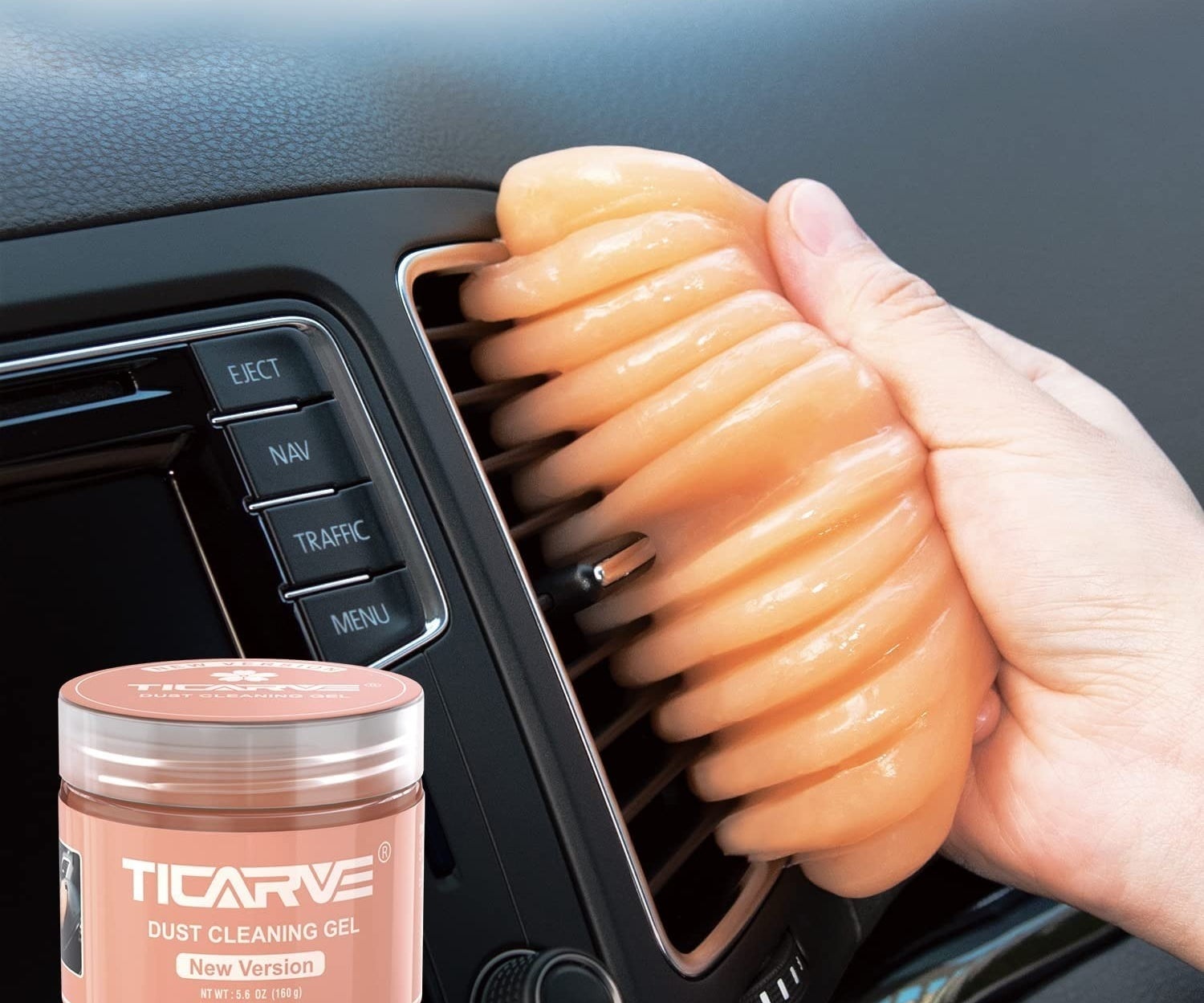 the orange putty being used to clean an AC car vent