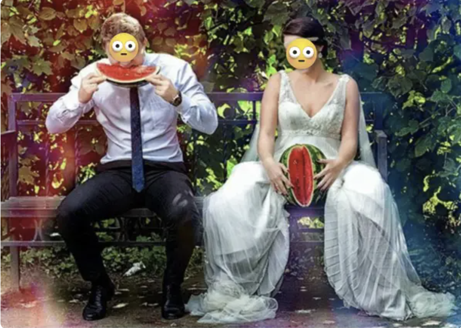 A bride and groom, with the groom eating watermelon sliced from the watermelon the bride is holding