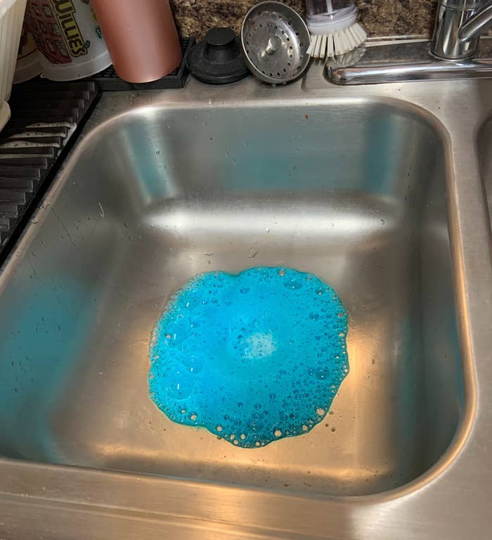 a reviewer photo of the blue foam in the sink