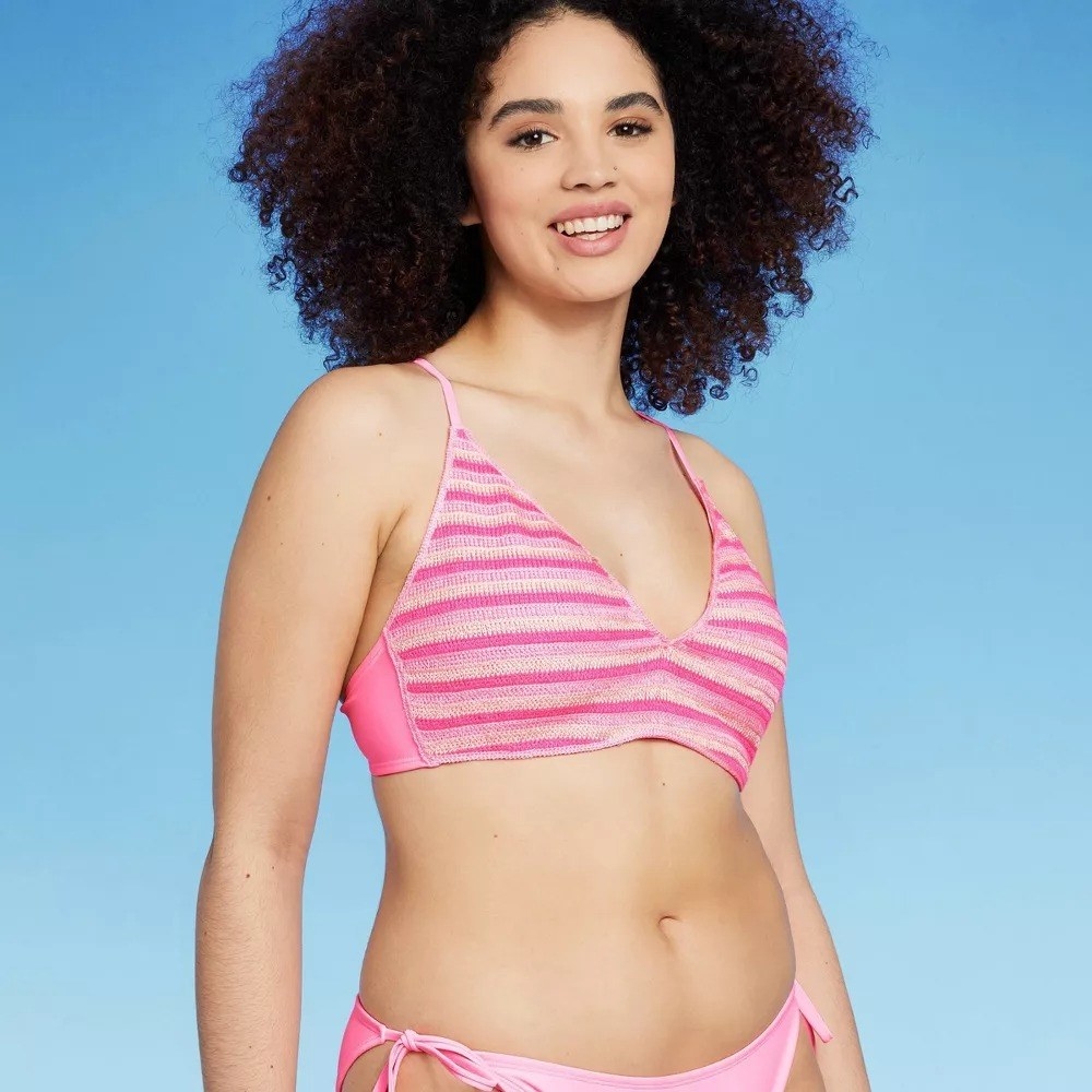 Image of model wearing pink bathing suit