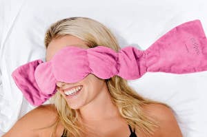 A model with the pink mask draped over their face