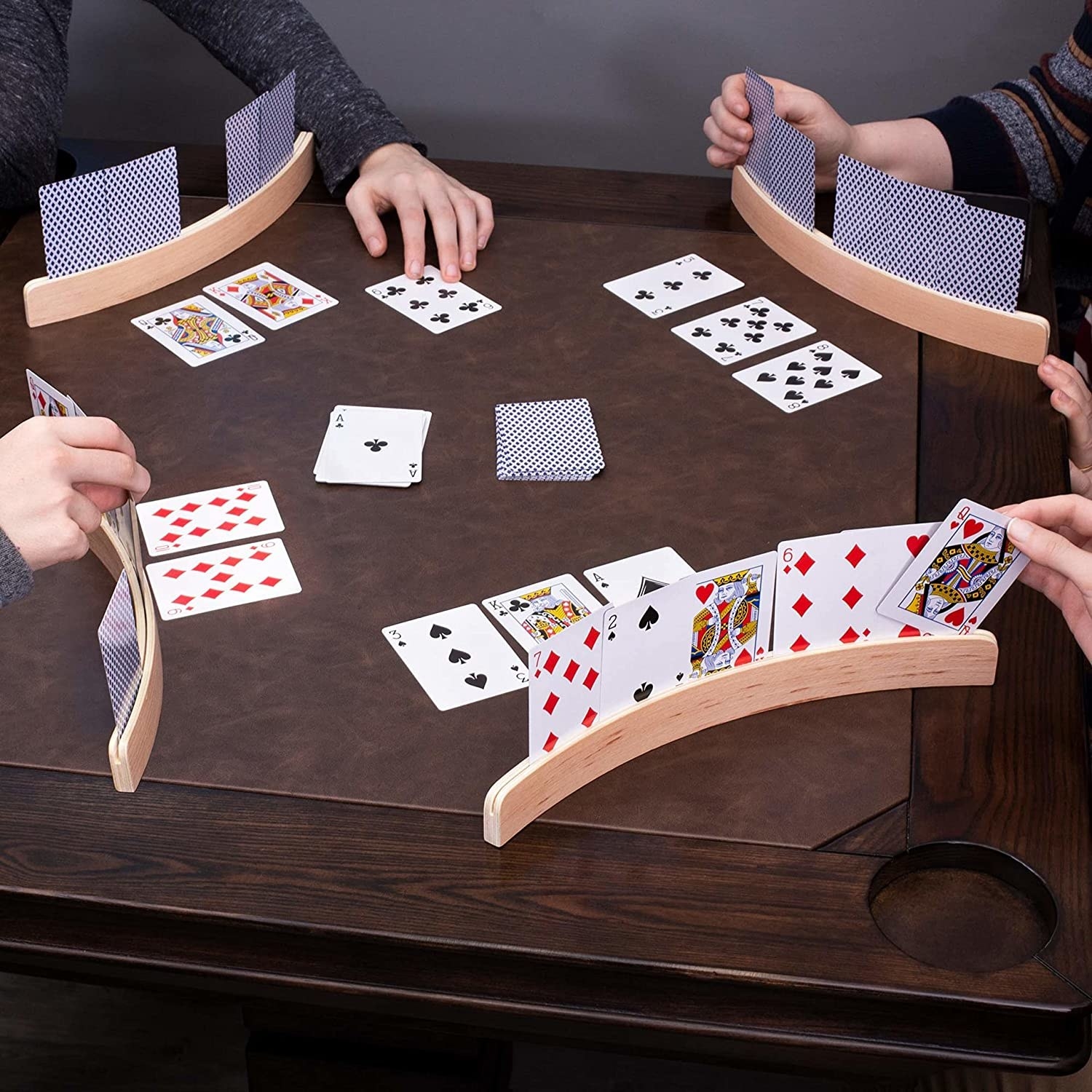 Four people using the card holders at a table