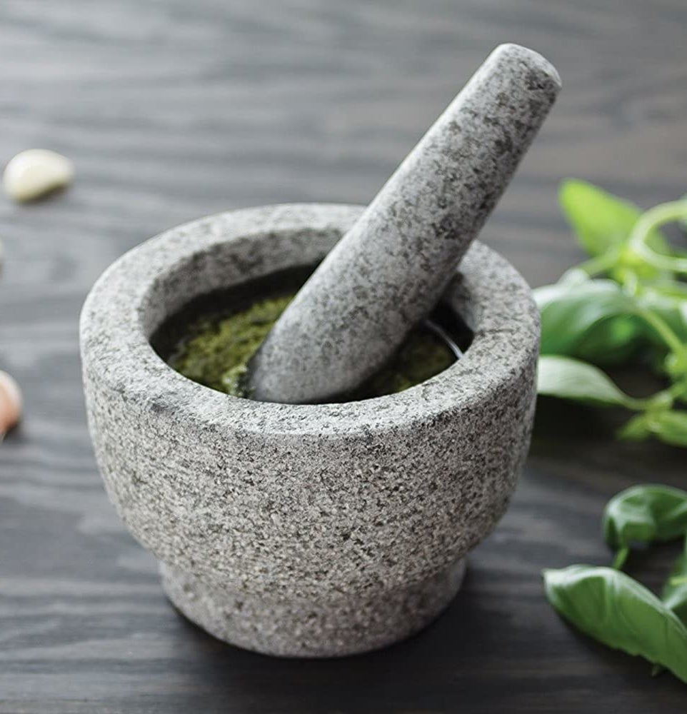 The mortar and pestle with basil in it