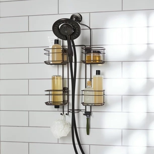 an oil rubbed bronze shower caddy with four holders against a white shower wall