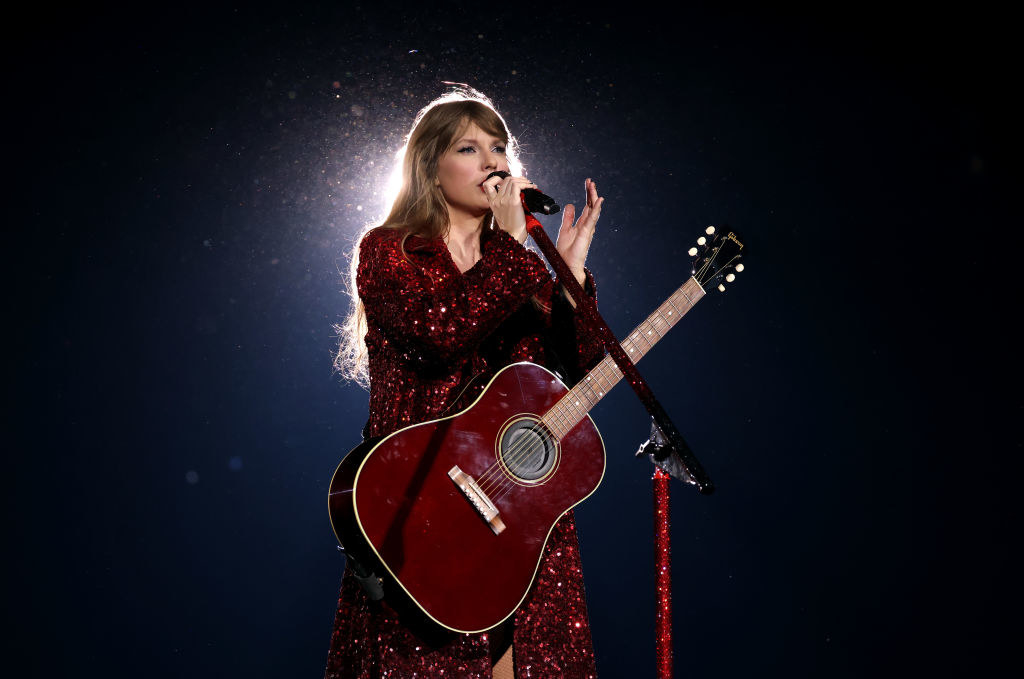 wearing a red bedazzled dress with a red guitar