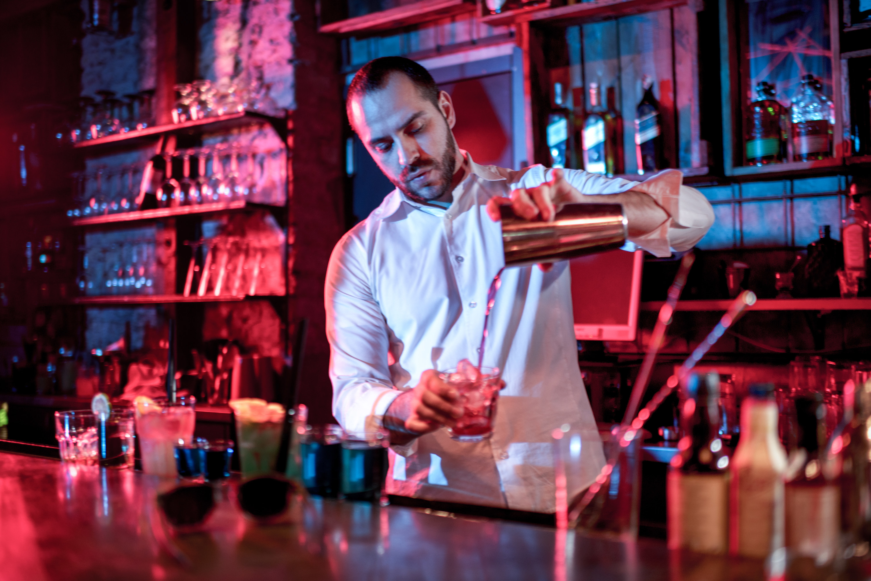 A bartender prepares a drink