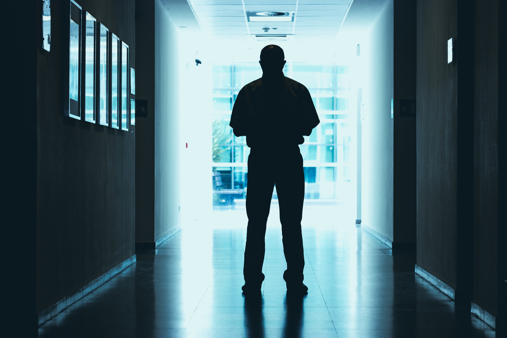 man standing in the dark hallway