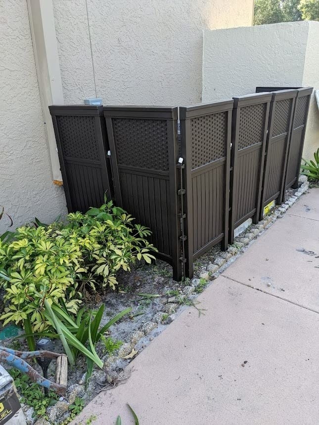 the brown privacy screen panels concealing a reviewer&#x27;s AC unit