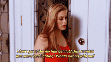 a gif of cher from clueless dealing with an existential crisis