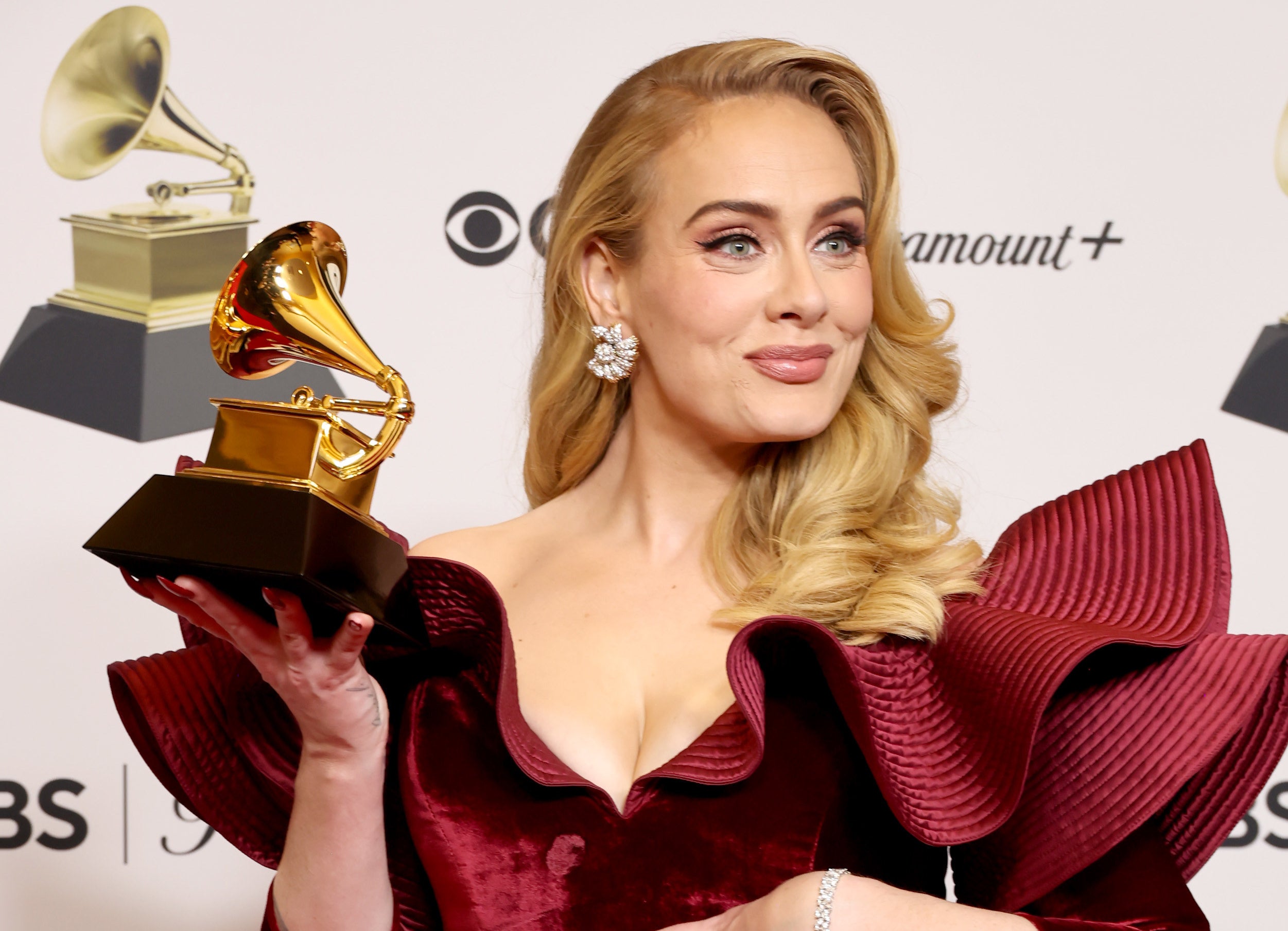 Adele poses with GRAMMY award