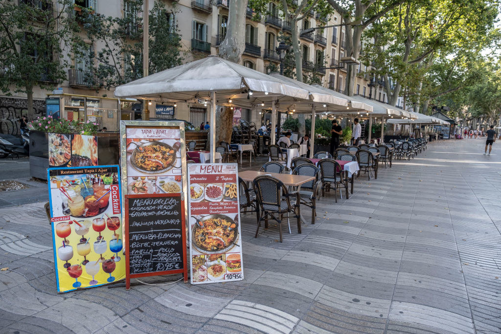 A restaurant with photos of the menu outside.