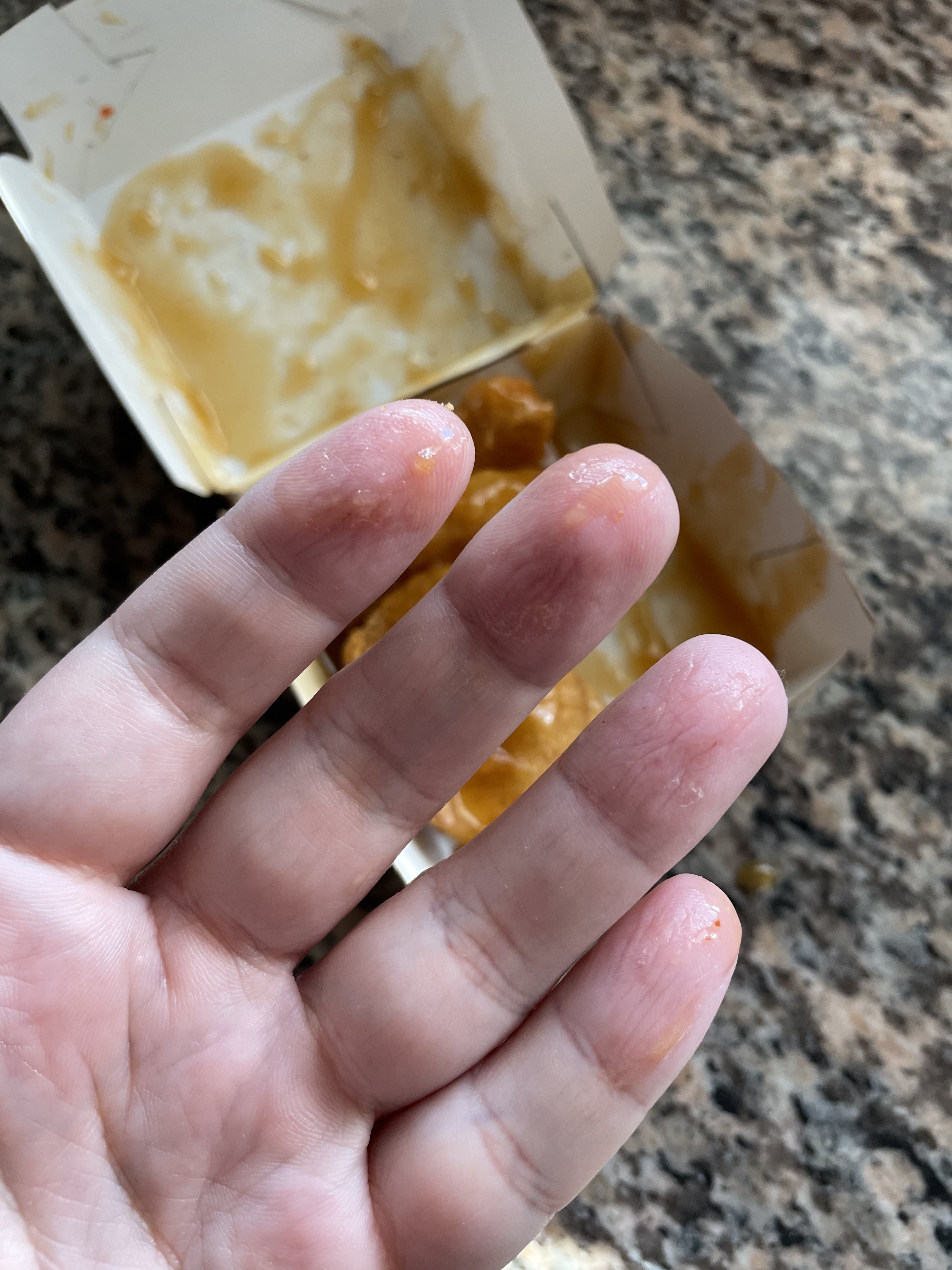 Close-up of fingers with some sauce on them