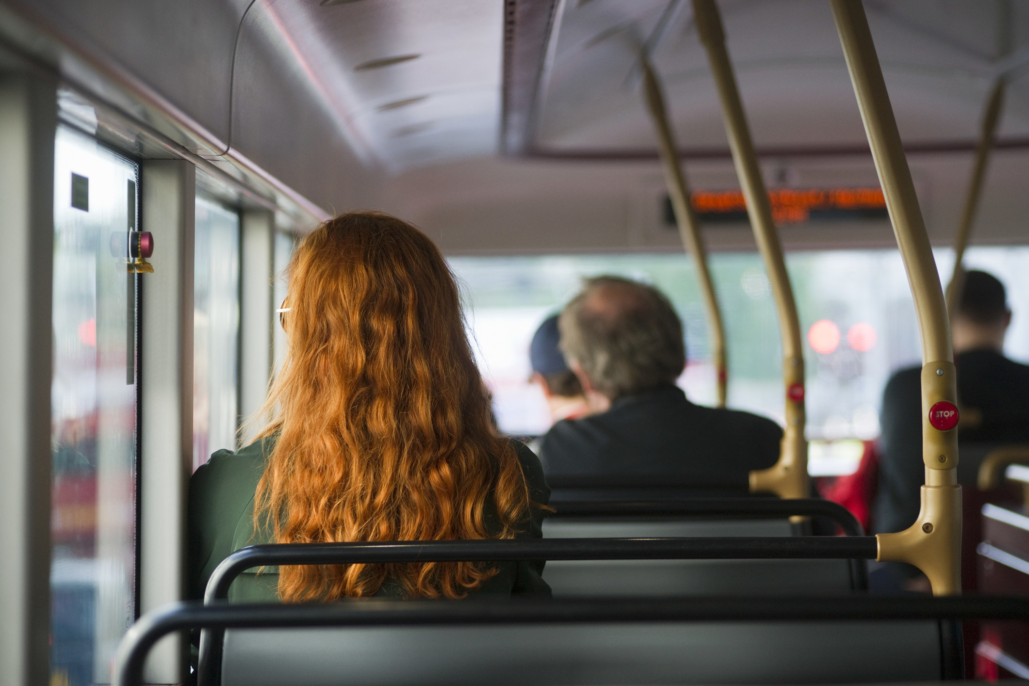 Rear view of commuters on a bus.