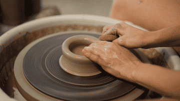 someone working a pottery wheel