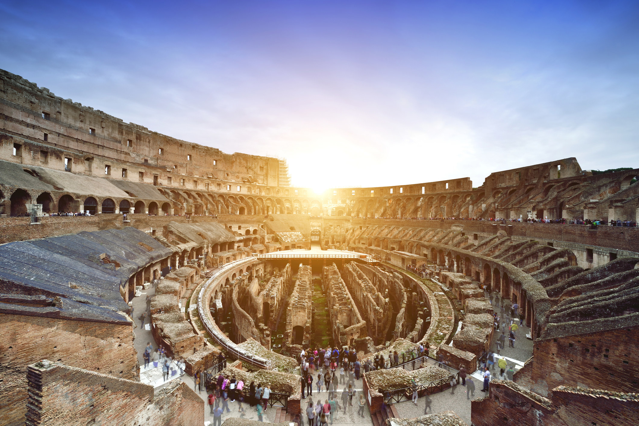 Tourists at the Colosseum at sundown.