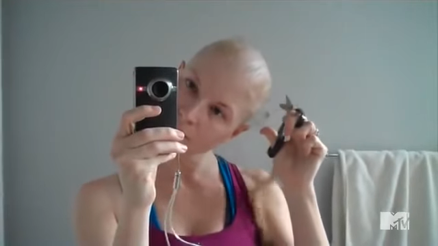 Diem cutting her hair from her balding head
