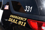 A police car with 'Emergency Dial 911' on its side parked in Santa Fe, New Mexico.