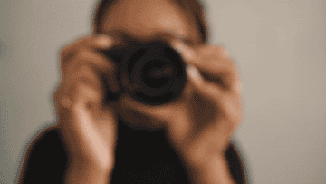 a person with a camera coming into focus