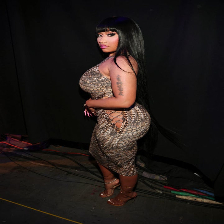 Nicki in a body-conscious dress with side lace-ups