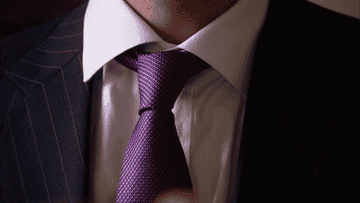 someone adjusting their tie