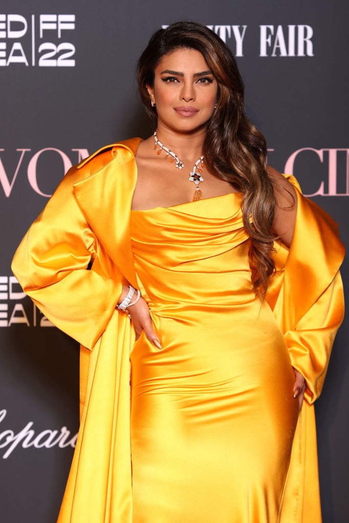 Priyanka in a yellow satiny gown with matching jacket