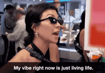 GIF or Kourtney wearing sunglasses and saying &quot;My vibe right now is just living life&quot;