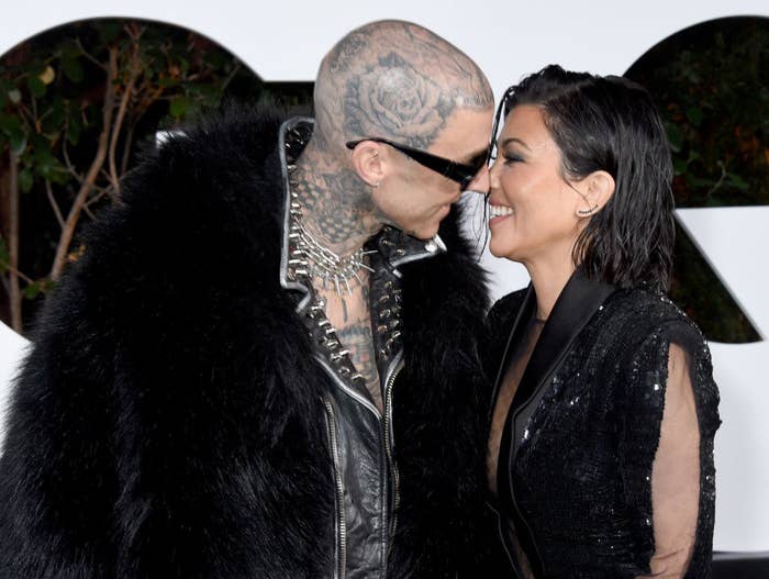Travis and Kourtney smiling at each other and touching noses