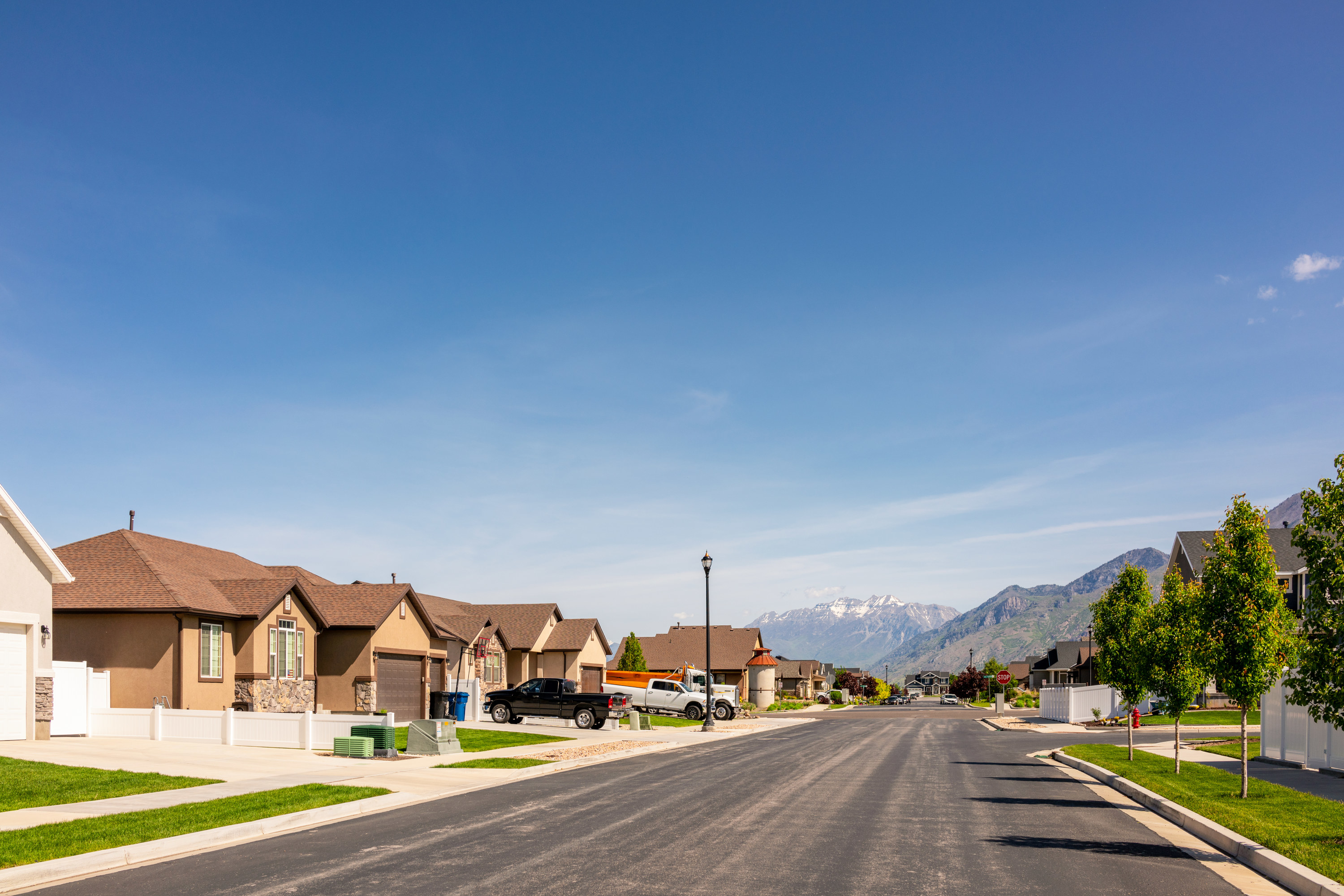 A view down the street of a modern suburban housing development to the south of Salt Lake City in Utah, USA