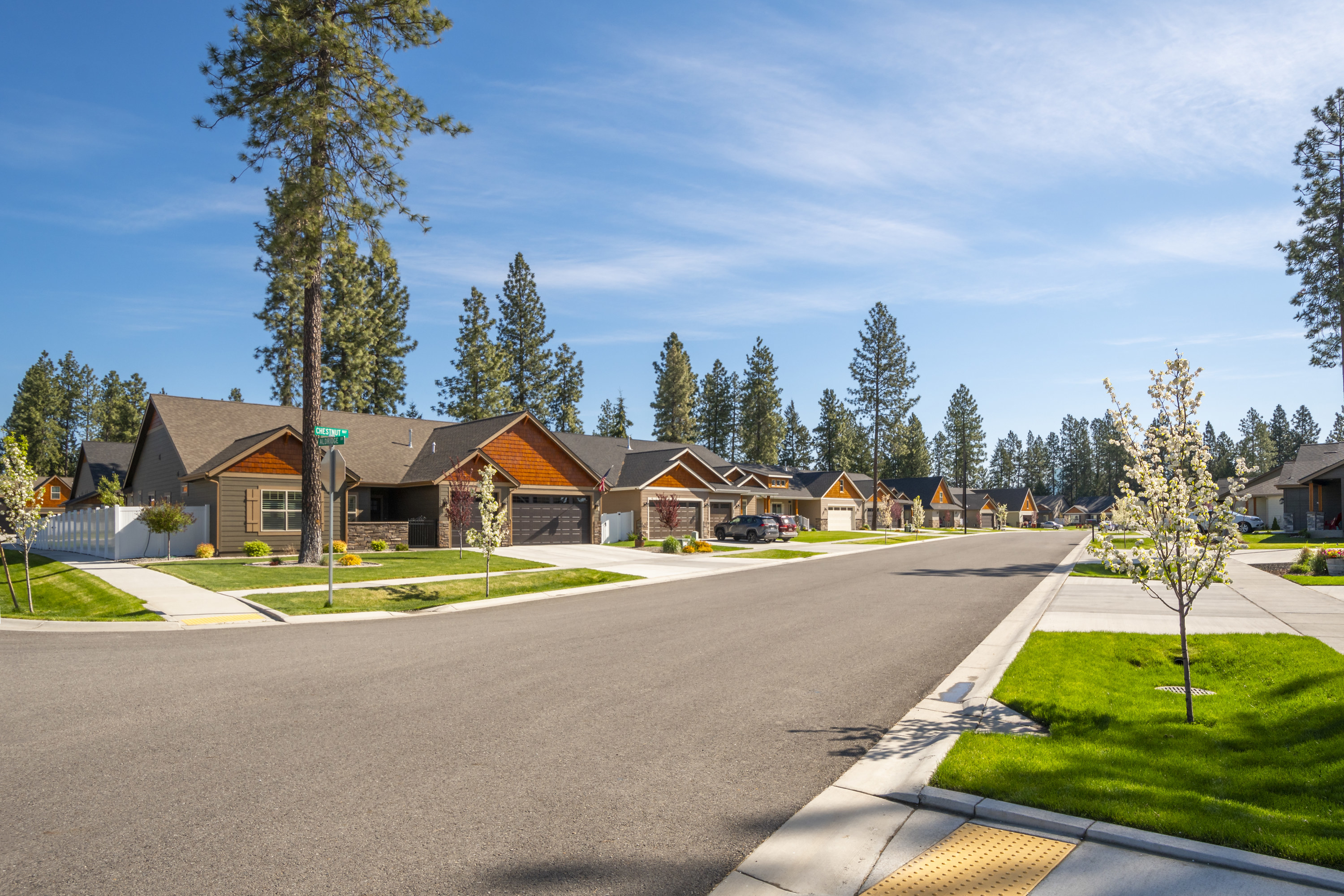 A row of new single story homes with garages on a suburban street in the city of Coeur d&#x27;Alene, Idaho