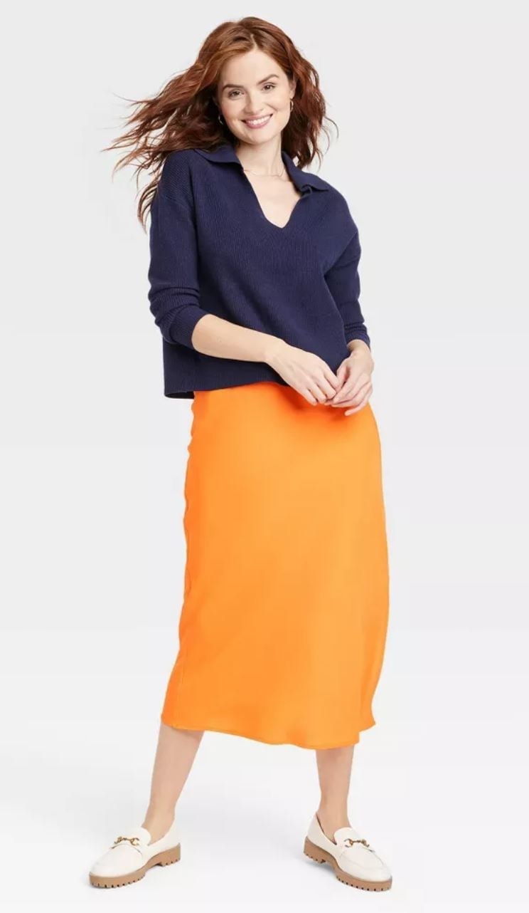model wearing orange slip skirt