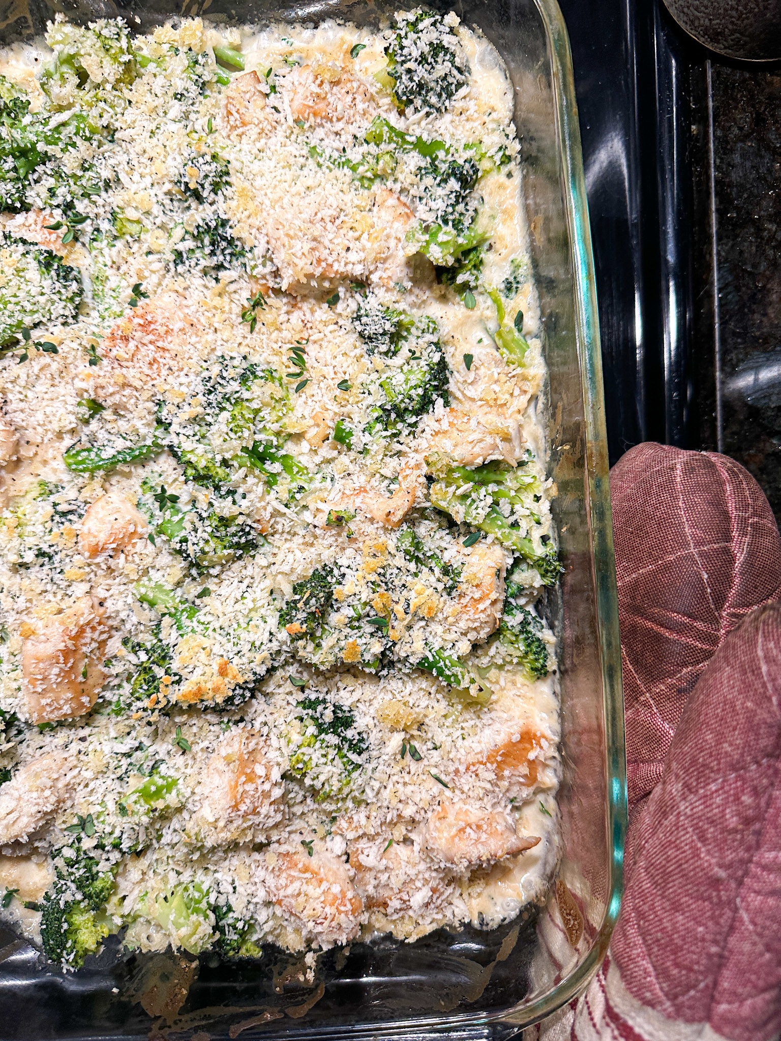 Casserole dish with chicken and broccoli casserole inside, topped with crispy bread crumbs