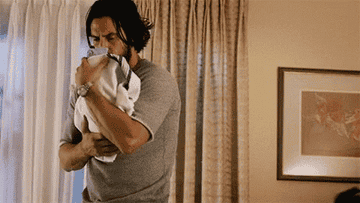 Jack from &quot;This Is Us&quot; rocking a newborn.