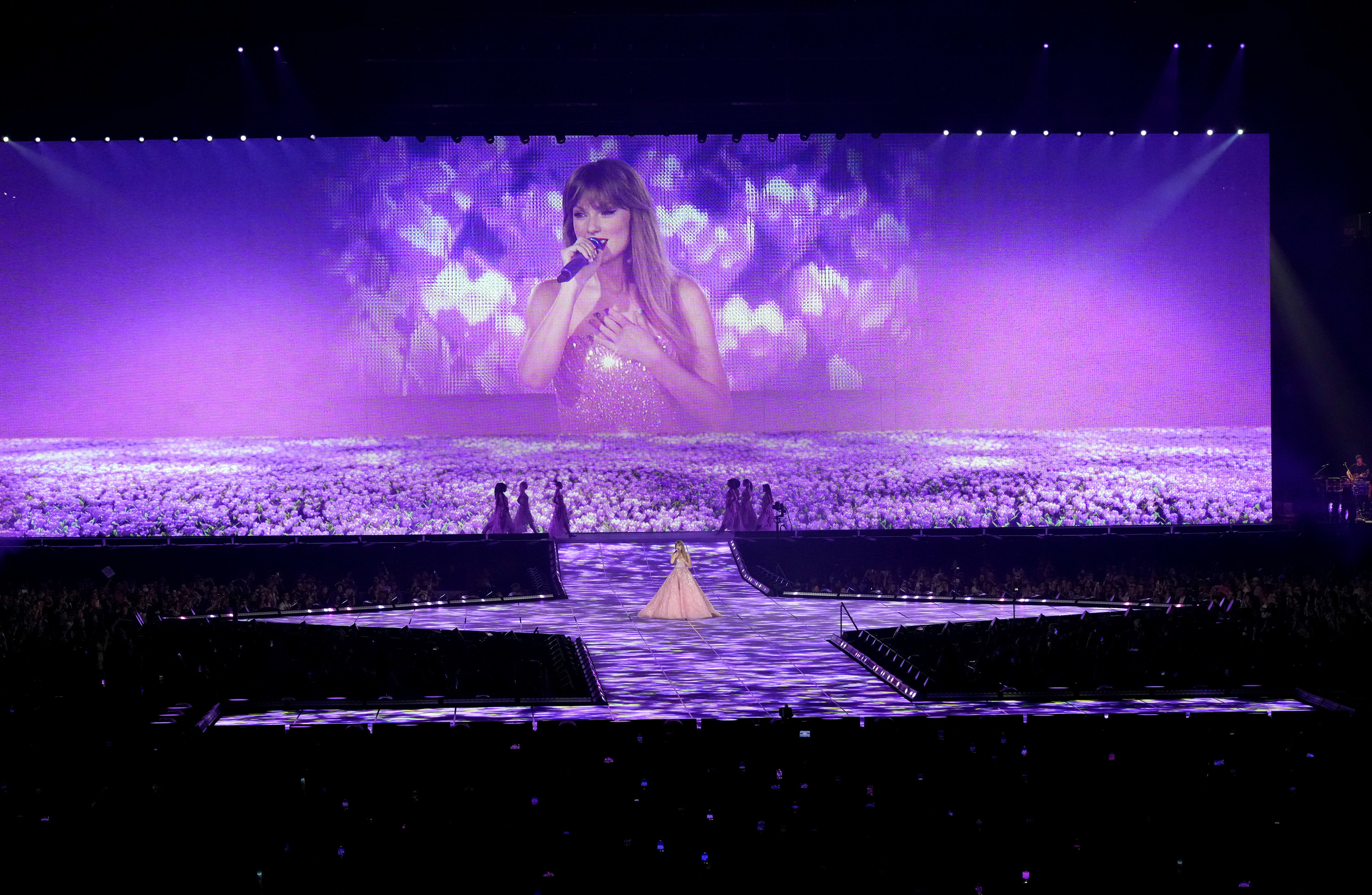 A wide-view of Taylor&#x27;s stage with the singer projected on the big screen