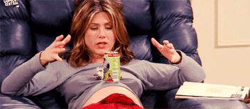 Jennifer Aniston balancing a soda on her pregnant belly.