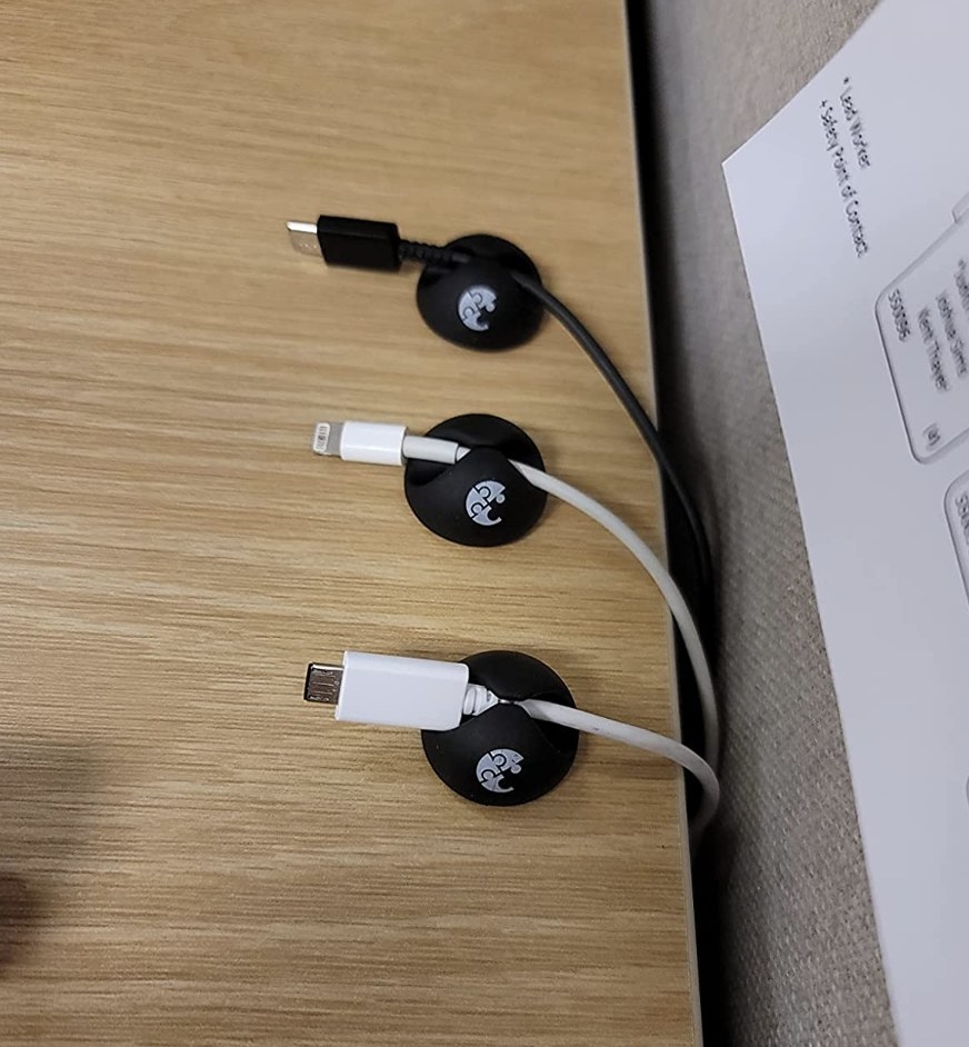 The clips on a desk with cables in them