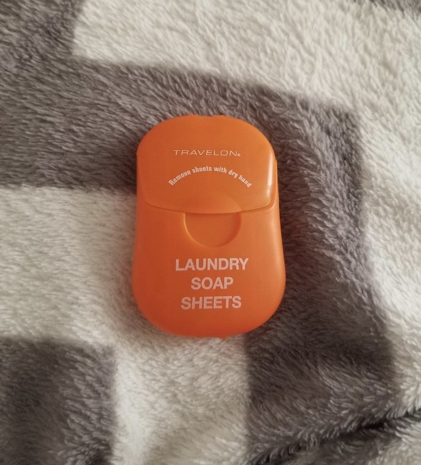 the product in an orange container on a blanket