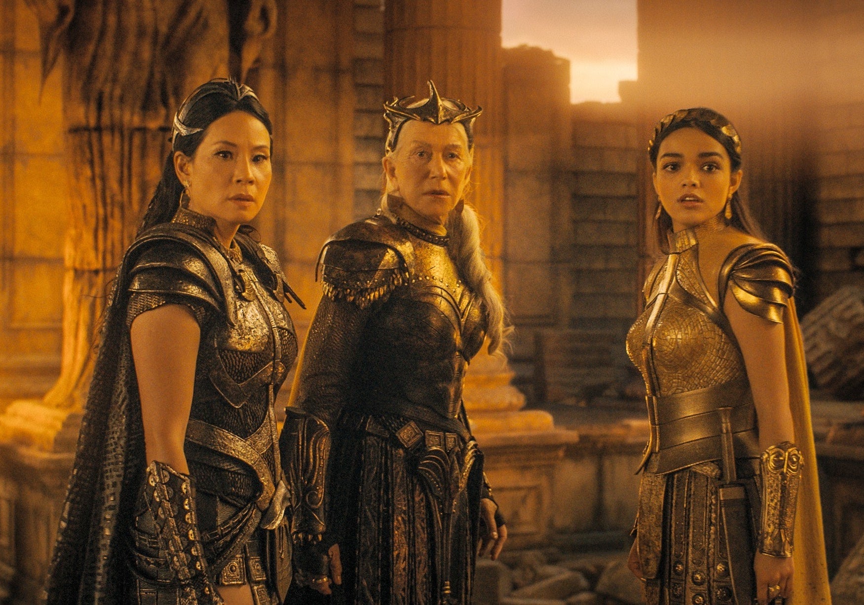 Rachel wears a suit of armor while standing with her costars in the film