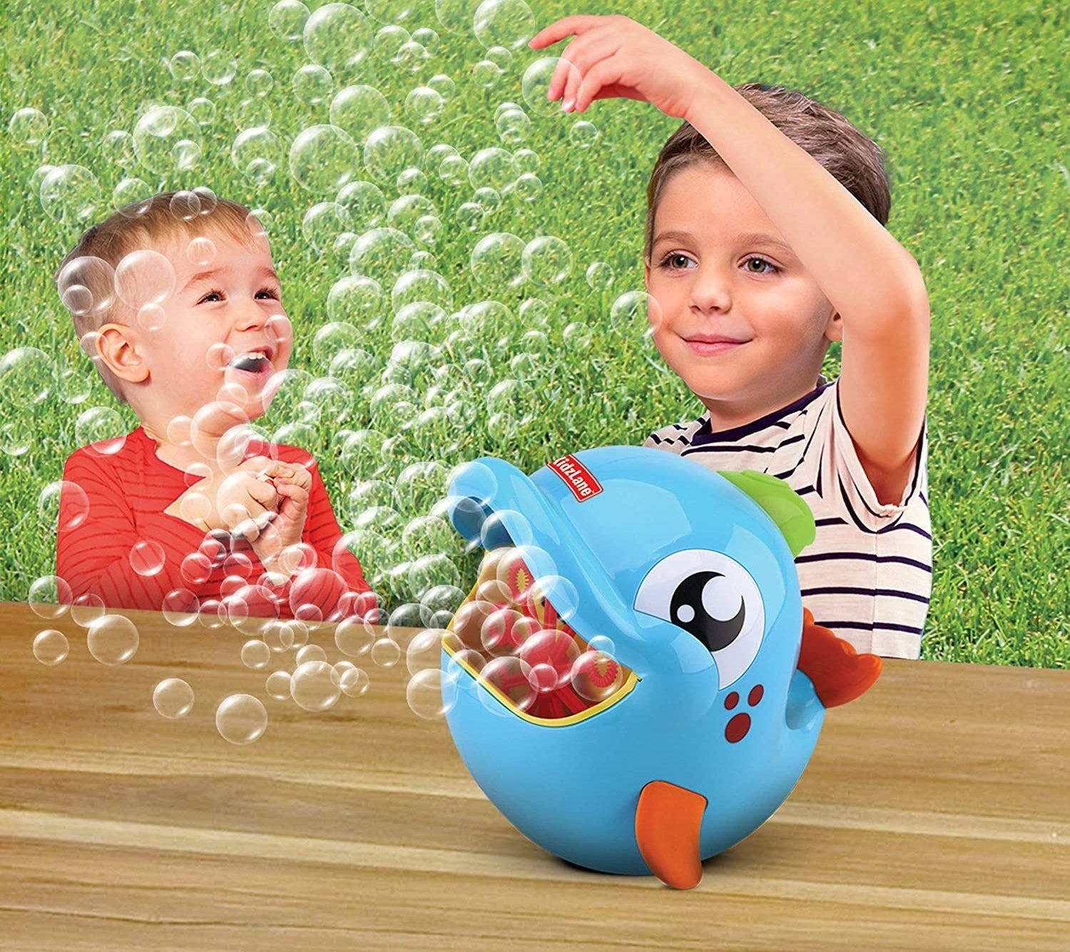 Light blue dolphin bubble machine toy being enjoyed by two children outside